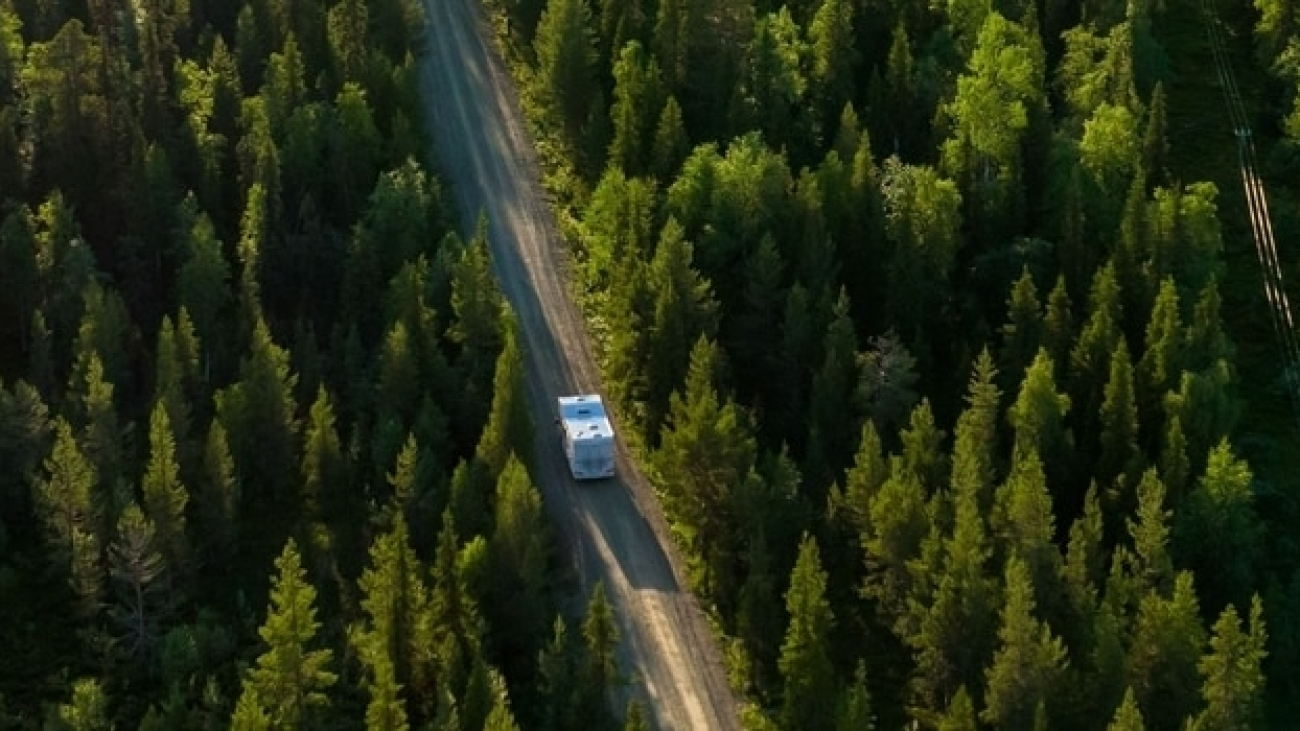 Aerial,View,Following,A,Camper,Van,,At,Lake,Pallasjarvi,Driving